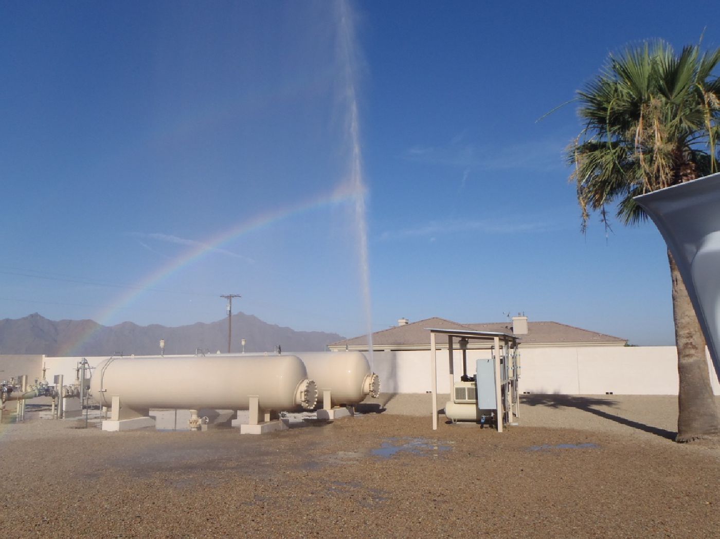 A water distribution system leak adjacent to a surge tank